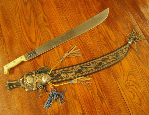 Columbia, S.A. Joaquin Machete: Columbia, S.A. Joaquin Machete. Engraved inscription on blade says, ''To Cpt West From The Officers of the A. G. Section Ft. Amador C.Z. 72-73.'' Machete measures 27''Lx4''W. Scabbard is leather and m
