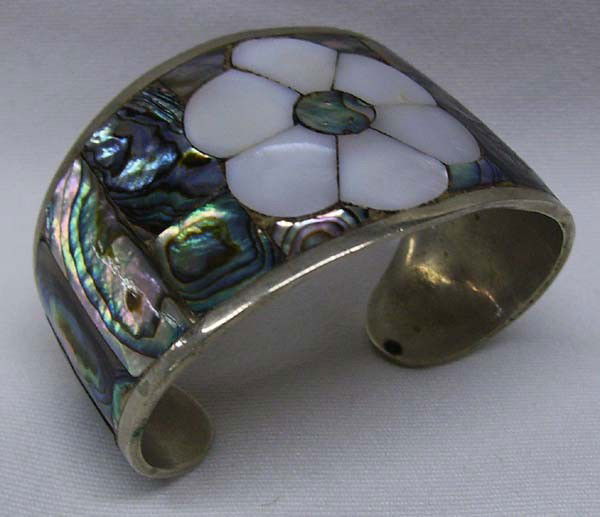 Mexican Abalone & Shell Silver Bracelet: Mexican Abalone & Shell Silver Cuff Bracelet. Measures 6 1/4'', including opening. Abalone inlay with large shell inlaid flower. Marked ''Hecho En Mexico''. Buyers Pay Actual Shipping and Handling Cha