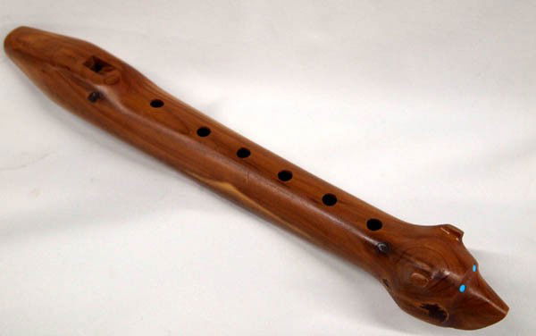 Navajo Cedar Flute Carved by Darrell Bedoni: Native American Navajo Cedar Flute Carved & Signed by Darrell Bedoni. End of the flute is a carved bear head with inset turquoise eyes. The flute comes with an instruction book written by the flute ma