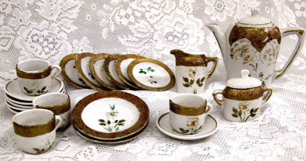 Vintage Child's Tea Set 21 Pieces: Vintage Child's Tea Set 21 Pieces. The tea pitcher is 5''Hx5.25''W(spout to handle). Includes 4 cups (one with broken handle), 6 saucers, 6 small plates, 2 large plates, cream, sugar and tea pot. Buye