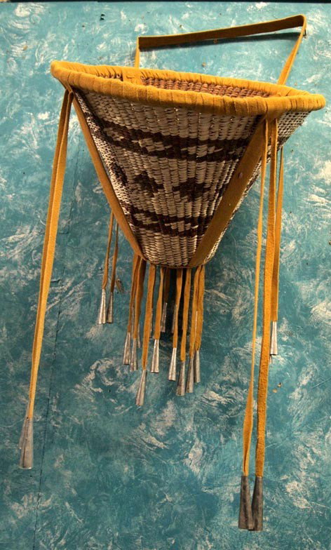 Apache Burden Basket Made by Evelyn Ward: Native American Apache Burden Basket Made by Evelyn Ward. Large two color basket with deer hide leather trim. San Carlos Apache, 2005. Measures 15'' diameter at top, 7'' diameter at bottom and 11.5'' 