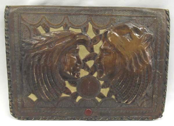 Mexican Hand-tooled Leather Purse: Vintage Mexican Hand-tooled Leather Purse. Envelope style purse, measuring 10'' x 7''. Handsome carved Indian heads on front with snap closure. Interior is lined in suede with 2 pockets, zippered pock