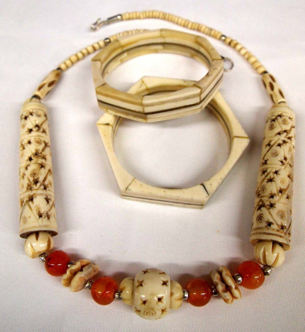 Bone and Brass Bangle Bracelets & Bone Necklace: DESCRIPTION: The bracelets are very similar and have brass inlay; one is hexagon and one is octagon. The necklace has two long hollow carved tube beads and a carved hollow center bead as well as disc 