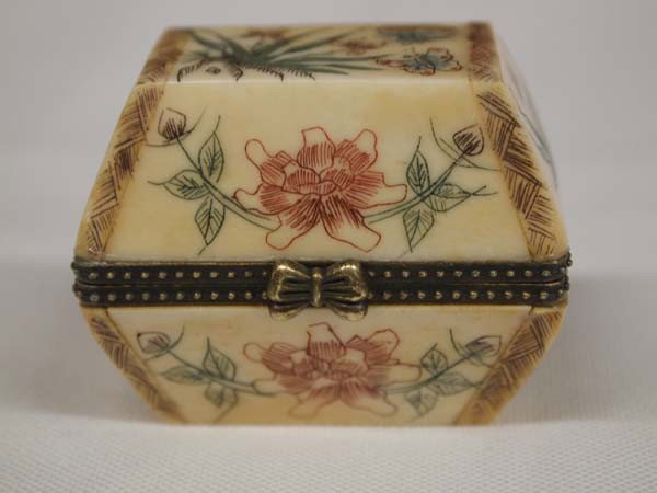 Scrimshaw Carved Bone Pill Box: DESCRIPTION: Beautifully carved bone flower and butterfly designs. Decorative brass trim on opening. SIZE: Measures 2-1/8''x1.5''. Buyer pays actual shipping and handling charges. (see terms and condi