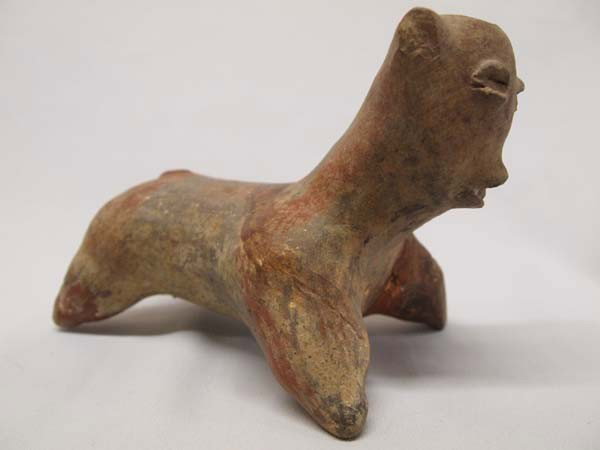 Precolumbian Style Pottery Dog Statue: PUEBLO: Precolumbian Style ETHNICITY: Mexican DESCRIPTION: Precolumbian Style Pottery dog statue. Has been glued, with some missing pieces. SIZE: Measures approx. 5 1/2''H x 7 1/2''L x 4 3/4''W. Buyer
