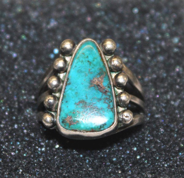 1940 Navajo Sterling Turquoise Ring: DATE:1940 PUEBLO: Navajo ETHNICITY: Native American DESCRIPTION: Natural green turquoise nugget - has small rough spot in matrix. Five silver balls on side of turquoise cabochon. SIZE: Ring size 7.5. 