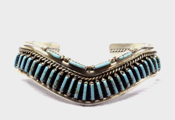 Zuni Sterling Silver Turquoise Bracelet Hallmark: PUEBLO: Zuni ETHNICITY: Native American DESCRIPTION: Gracefully shaped sterling silver bracelet with needlepoint turquoise and rope twist design. Stamped on the back with artist's hallmark, ''N STERLI