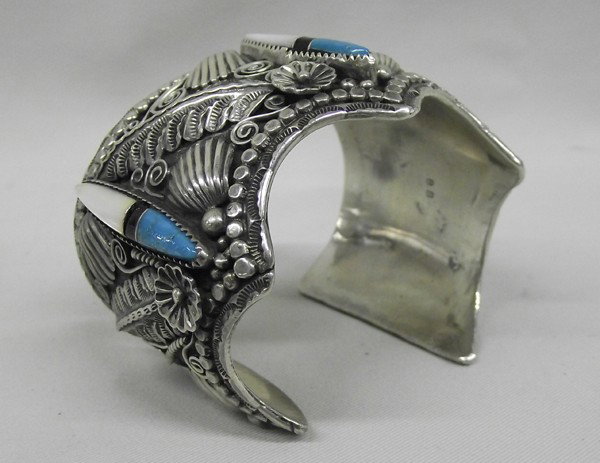 Navajo Sterling Bracelet - Benjamin Becenti: PUEBLO: Navajo ETHNICITY: Native American DESCRIPTION: Magnificent Bracelet. Heavy and wide. Sterling silver with Mother Of Pearl, Jet and Turquoise. Bracelet has lots of lovely Repousee work. Hallmar