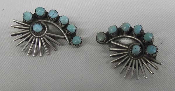 1940 Navajo Sterling Turquoise Clip On Earrings: AGE: 1940 PUEBLO: Navajo ETHNICITY: Native American DESCRIPTION: Early turquoise sterling silver clip on earrings. 7 turquoise stones in each earring. SIZE: Measure approx. 2 1/4''L x 3/4'' wide. Buye