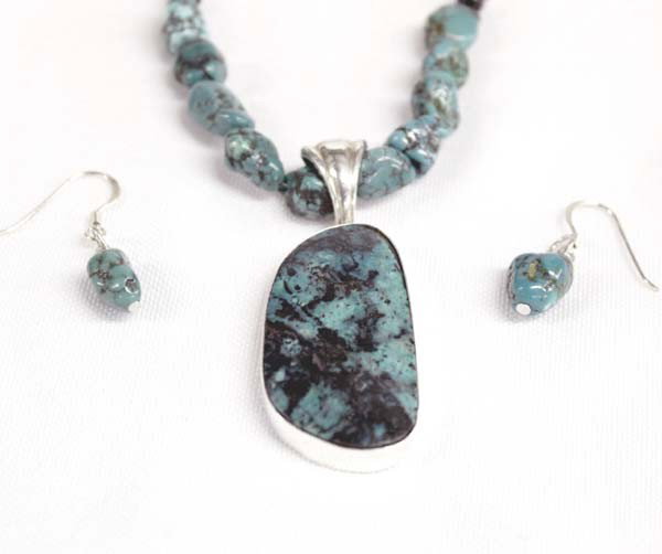 Silver Turquoise Chrysocolla Necklace Earrings: DESCRIPTION: Turquoise nuggets strung with onyx beads and stamped silver beads. Large chrysocolla cabochon set in sterling silver. Made by local Silver City, NM artist, Sally Hansen. Stamped on the ba
