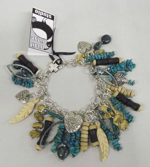 Quail Ridge One Of A Kind Charm Bracelet: DESCRIPTION: Unique and Delightful Fetishes and Feathers Charm Bracelet. Bracelet has turquoise nugget jocklas, carved bone feathers, picture Jasper buffalo fetishes heart charms and Chinese black and