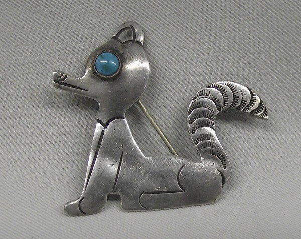 1950 Navajo Sterling Silver Turquoise Pin: DATE:1950 ETHNICITY: Native American DESCRIPTION: Adorable vintage Navajo sterling silver pin with turquoise eye, maybe raccoon or cat? Some wear but only adds to the character of pin. SIZE:1''H x 2''