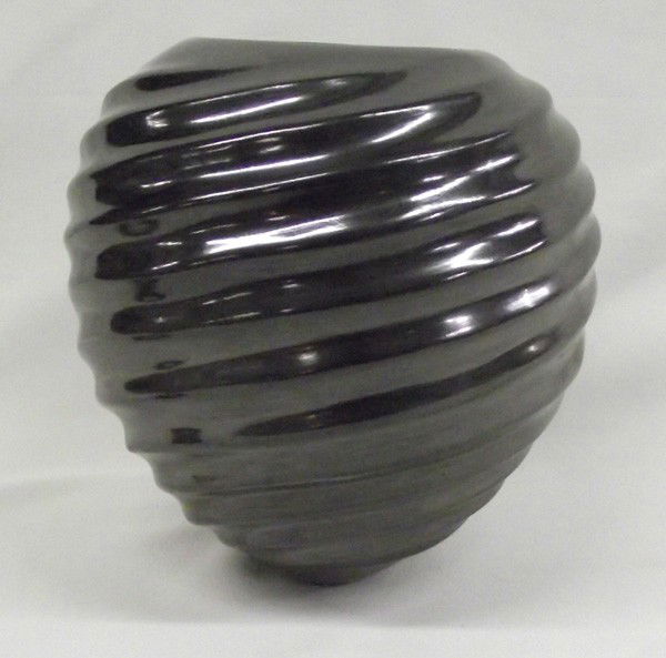 Mata Ortiz Black Swirl Design Jar-Alonso Sandoval: PUEBLO: Mata Ortiz ETHNICITY: Mexican DESCRIPTION: Highly burnished black swirl pottery. Beautiful even swirls. Signed on the bottom, ''Alonso Sandoval.'' SIZE: 7''Hx7''W (diameter at widest point).