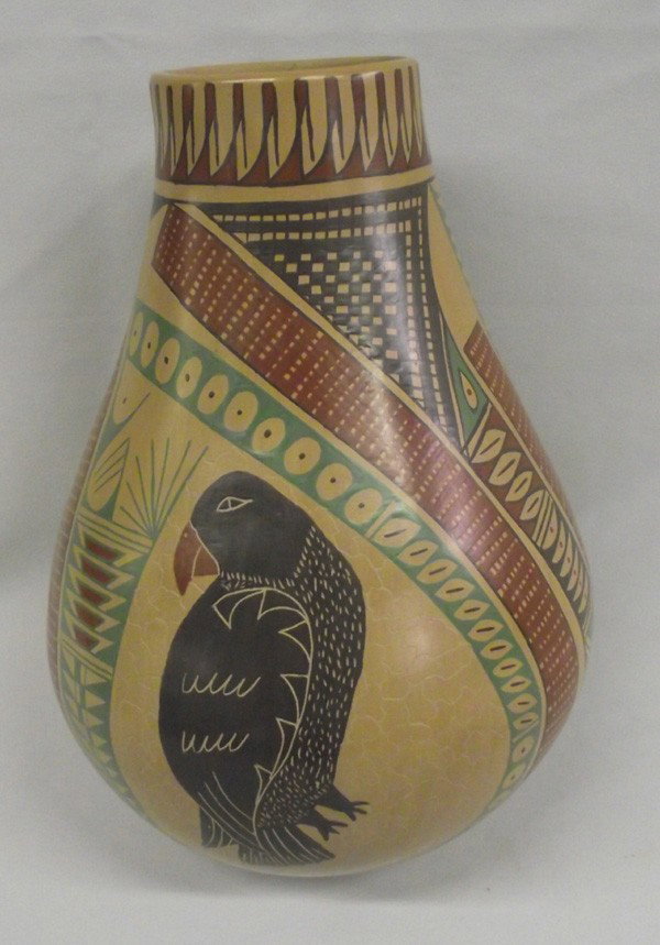 Mata Ortiz Polychrome Bird Jar-Alejandra Cota: PUEBLO: Mata Ortiz ETHNICITY: Mexican DESCRIPTION: Polychrome tall jar with two beautiful bird figures. Black, red and green on tan. Signed on the bottom, ''Alejandra Cota.'' SIZE: 10''Hx7.5''W (diame
