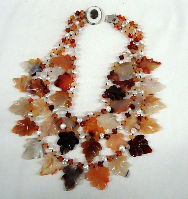 Carved Carnelian Leaves Pearl Cameo Necklace: DESCRIPTION: Stunning 3 strand multi colored, carved Carnelian leaves and beads with fresh water pearls strung together in fine fashion. The clasp inserts into an oval pearl with an decorative abalone