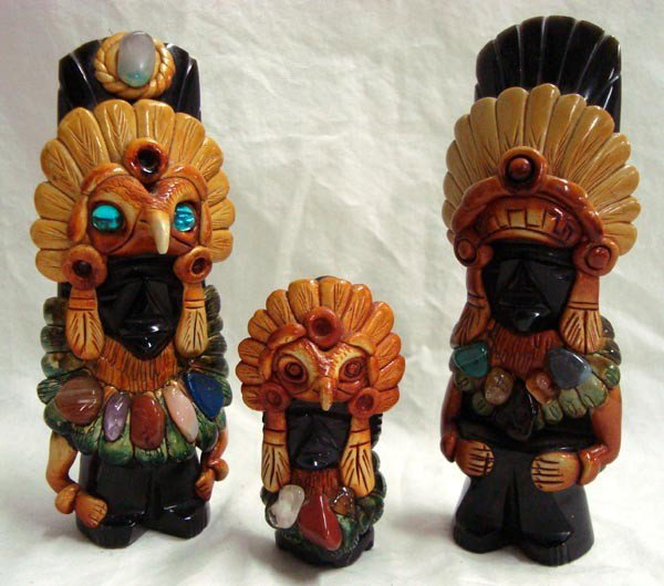 Three Obsidian Carvings, Totem Style: Three Obsidian Carvings, Totem Style. Uniquely decorative totem statues, tallest is 6'' x 2 1/4'' in width. Applied gem stones decorate these hand-painted statues.