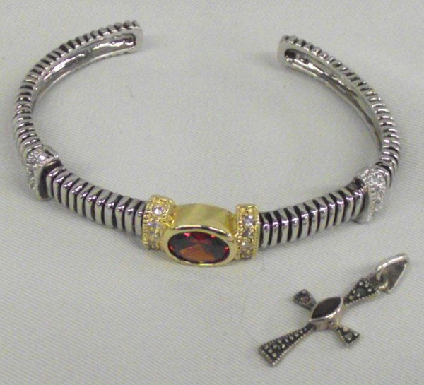 Sterling Gold Overlay Bracelet and Marcasite Cross: Sterling Gold Overlay Bracelet and Marcasite Cross Pendant. Garnet colored stone set in sterling silver with surrounds of rhinestones. Measures 7'' inside including opening and is 3/8'' wide. Cross pe