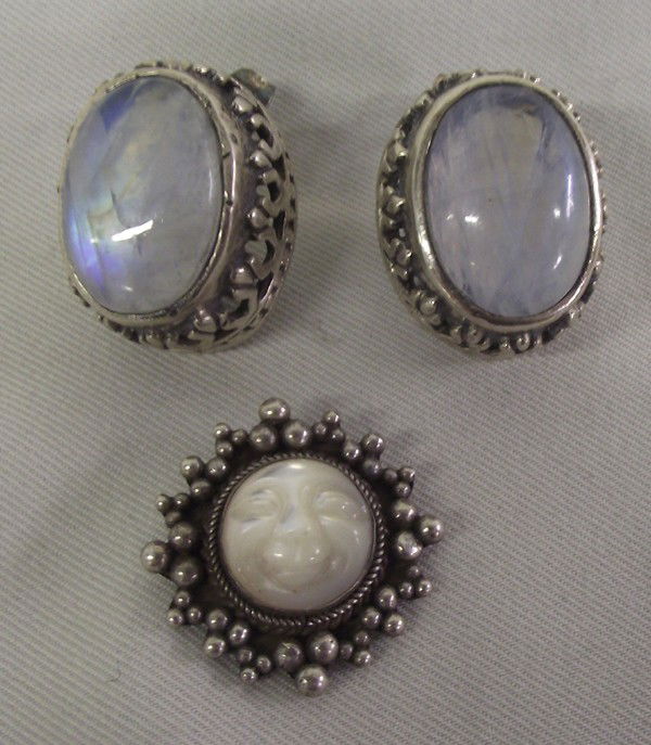 Moonstone Sterling Silver Earrings and Pendant: Moonstone Sterling Silver Earrings and Pendant. Eye catching blue moonstone earrings with deep sterling silver setting, for pierced ears. Measure 7/8''x3/4''. The pendant is white moonstone with a car