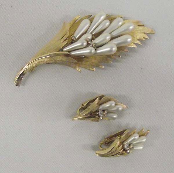 1960s-70s Gold Tone Jewelry Pin, Earrings: 1960s-70s Gold Tone Jewelry Pin, Earrings. The pin is simulated pearls with 4 set in rhinestones. It measures 3-3/8''Wx1-1/4''H. The earrings are clip on with simulated pearls and 3 set in rhinestones