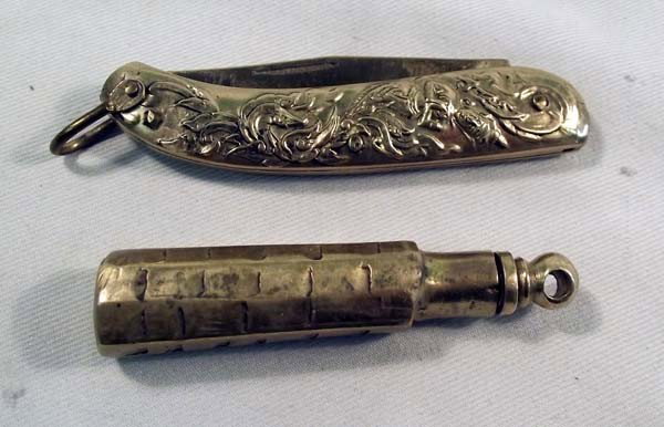 Antique Ladies Fancy Brass Knife & Perfume Bottle: Antique Ladies Brass Knife & Perfume Bottle. Single blade knife measures 3'' in length x 5/8'' wide. Heavy floral repousee work on the case. Perfume dauber measures 2 1/4'' long and 3/8'' wide. Dauber