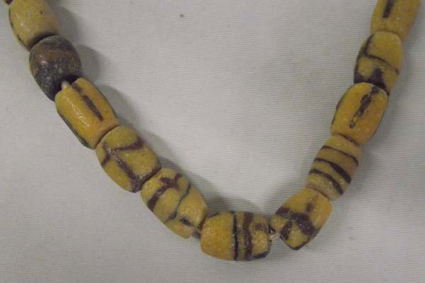 Antique Trade Bead Necklace: Antique Trade Bead Necklace, measures approx. 24'' end to end, straw string tied. Largest bead measures approx. .75''l.