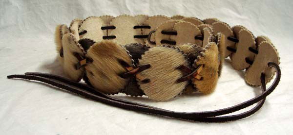 Eskimo Seal Skin Belt: Eskimo Seal Skin Belt. Round discs of seal fur with fabric backing, woven together with a leather strap. Each disc is approx. 1-7/8'' round and overall length of belt is 30'' not including leather tie