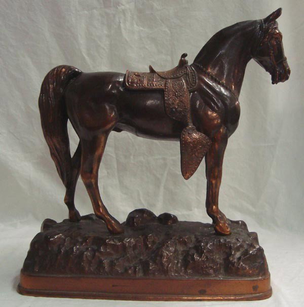 Vintage Metal Saddled Horse on Base: Vintage Metal Saddled Horse on Base. She wears her saddle proudly. Approx. 13''H x 11''L. Nice patina. A small hole is in the hollow base. No mark of maker or date. 9 pounds for mailing.