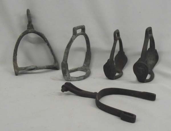 1800s Spanish Stirrups: 1800s Spanish Stirrups, found in New Mexico with a Geiger Counter. One Spur has Leaf embellishments and one spur has lion head embellishments. Measure approx. 3.5 x 3.5''.