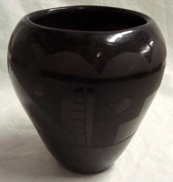 Santa Clara Pueblo, Black on Black Pot: Santa Clara Pueblo, Black on Black Pot. Some small signs of wear. 5''H x 4.75''W. The ancient 1550's New Mexico pueblo people are from the Tewa ethnic group.