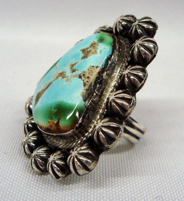 Navajo Turquoise Sterling Ring - Jesse Martinez: Native American Navajo Turquoise Sterling Ring - Jesse Martinez. Large ring has 16 domed star figures surrounding the large turquoise cabochon. Stamped on the back, ''JM'' and ''Sterling'' for Jesse M