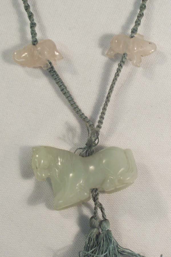 Oriental Jade Necklace: Oriental Jade Necklace. Animal fetishes on a braided string, horse, elephant, rabbits, dog and turtle. Measures approx. 30'' with 2'' tassels. Over the head style.