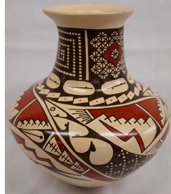 Mata Ortiz Polychrome Jar Red & Black on Tan: Mata Ortiz Polychrome Jar Red & Black on Tan. Stylized geometric designs in red and black on a light tan background. Elegant shape. Name on bottom is difficult to read; may be ''Josue N.O''. Very smal