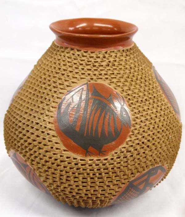 Mata Ortiz Very Large Textured Jar - Jose Gonzalez: Mata Ortiz Very Large Textured Jar - Jose Gonzalez. Various black animal designs inside circles of red. Deep pencil-push texture all around the body of this tall jar. Signed on the bottom, Jose Gonzal
