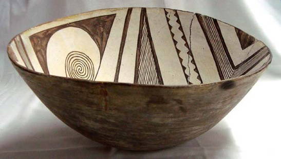 Prehistoric Geometric Classic Mimbres Bowl: Prehistoric Geometric Classic Mimbres Wind Pattern Black on White Bowl, measures approx. 5 7/8''H x 13''W. No restoration, glued only on 1/3 of bowl. Beautiful Negative Wind Pattern on opposing sides.