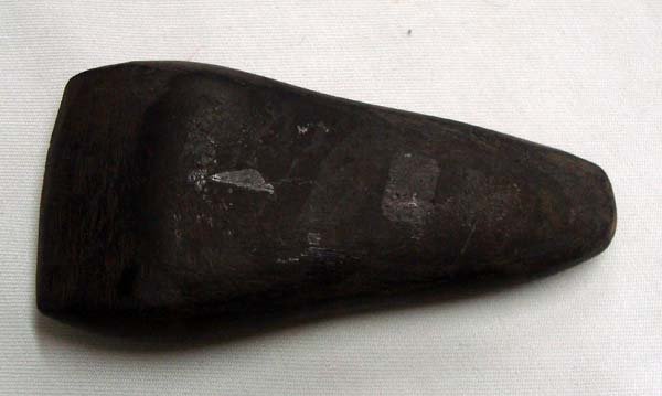 Stone Celt Axehead Tool: Stone Celt Axehead Tool, Age & Origin Unknown. Measures approx. 4.25''L x 2''W x .75'' Depth.
