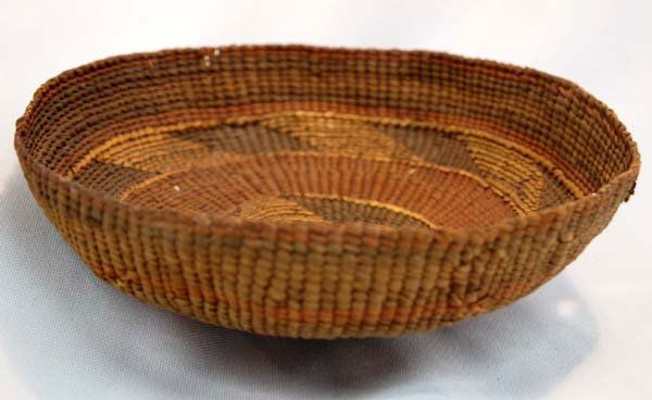 1910-20 Tlinget Basket: 1910-20 Native American Tlinget Basket. Very tightly woven basket with many designs in 3 different colors. Small hole on one side. Measures 2.5"H x 5.75"W.