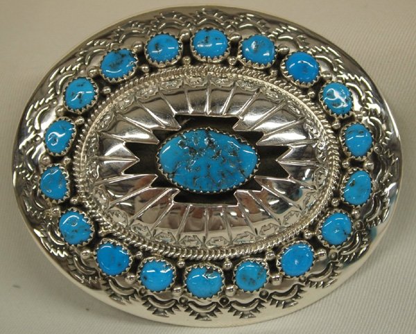Navajo Sterling Silver Turquoise Buckle by Muskett: Native American Navajo Sterling Silver Turquoise Buckle by artist Wilbert Muskett Sr. Buckle has shadow box center stone with 18 turquoise cabochons around the buckle. Measures approx. 2.25 x 3''. Hal