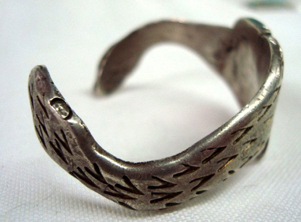 Hand Wrought Ingot Bracelet-Snake Motif: Hand Wrought Ingot Bracelet-Snake Motif. The bracelet measures 6'', inside measurement and is 7/8'' wide.