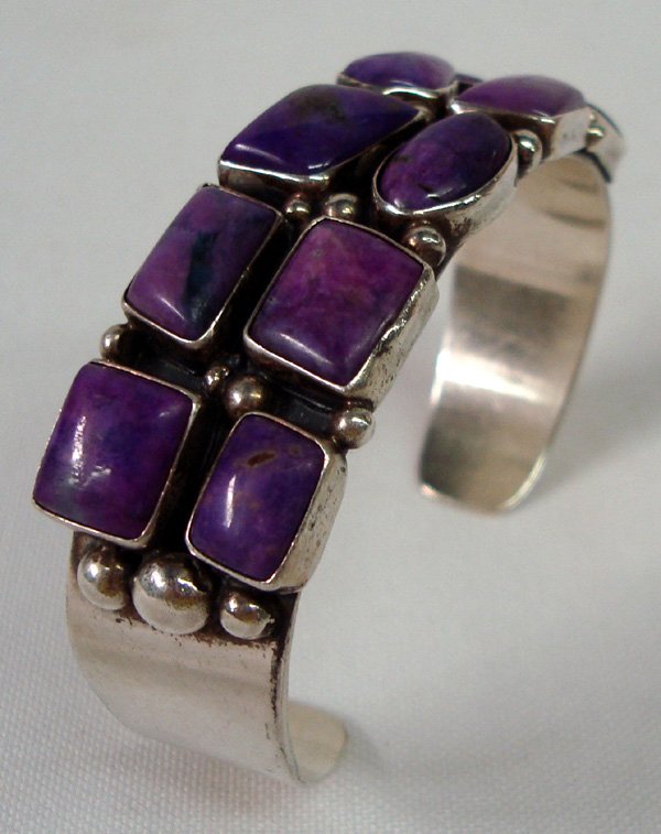 Navajo Sterling Sugilite Bracelet - Secatero: Bold Native American Navajo Sterling Silver Sugilite Bracelet by artist Philbert Secatero. Bracelet has 7'' inside measurement, with a width of 1.5'' Wide and weighs approx. 52 grams. There are ten be