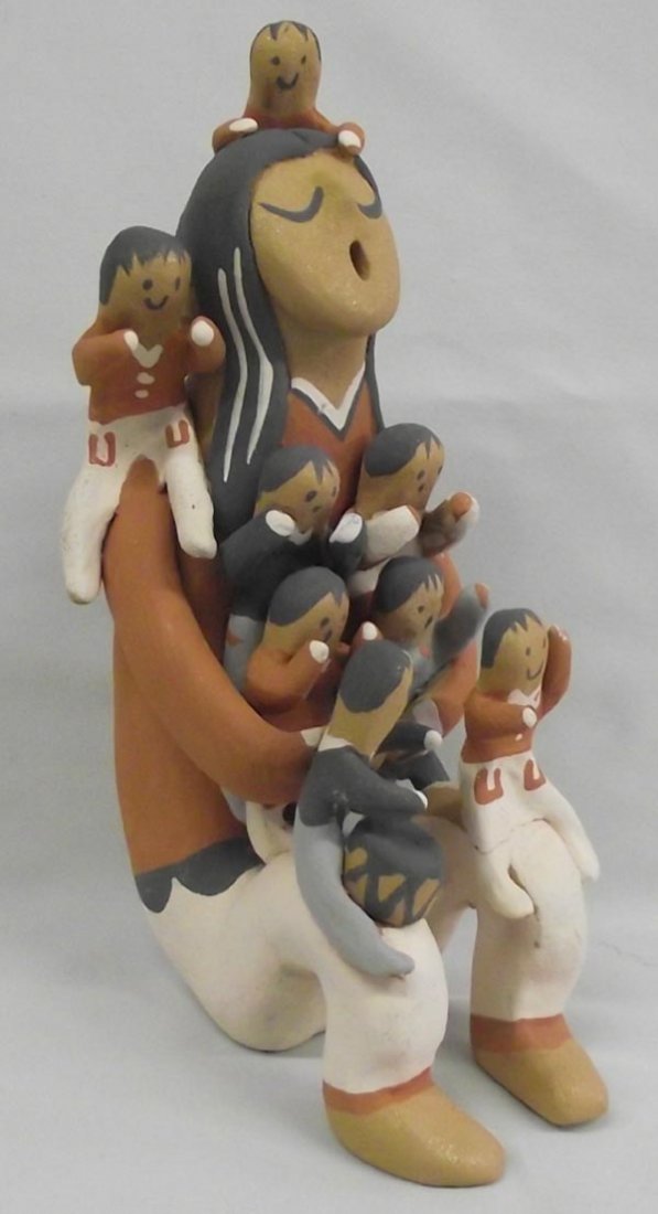 Taos Storyteller Doll - Juanita Jesus: Native American Taos Storyteller Doll. Mama has three babes on her shoulders, four in her lap and two on her knees! The babe on her left knee fell has a little crack across her legs. Measures 9''Hx5.5