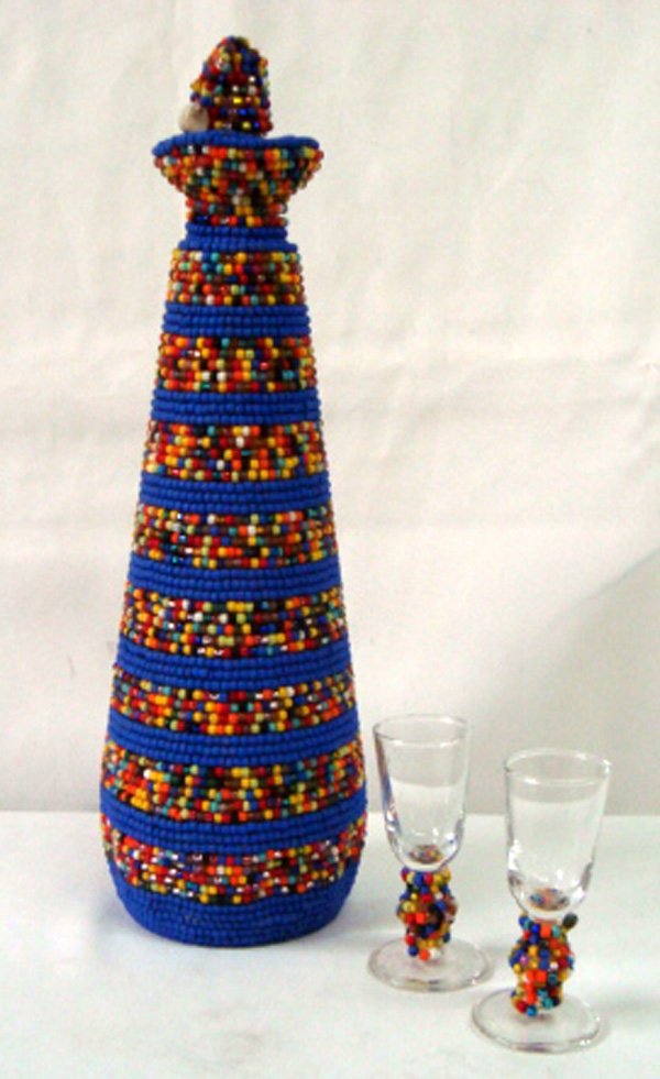 Hand Beaded decanter,Liquor Glasses- Kills Thunder: Hand Beaded decanter and two liquor glasses hand beaded by artist Kills Thunder. Decanter is 13''H x 4'' diameter, has a beaded cork top. Very colorful and fun.
