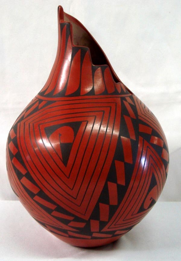 Mata Ortiz Black on Red Cutaway Rim Jar - L Soto: Mata Ortiz Black on Red Cutaway Rim Jar - L Soto. Tall jar with step cut design on the rim. Signed on the bottom, ''Lucy Soto.'' Measures 13.5''x9''W.