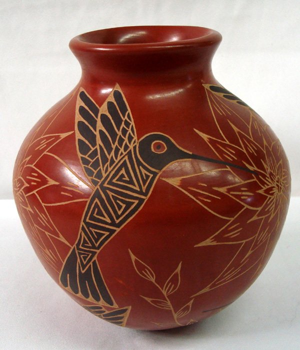 Mata Ortiz Hummingbird Jar - Ceci Bugarini: Mata Ortiz Hummingbird Jar - Ceci Bugarini. Rich reddish brown background with beautiful hummingbirds etched and painted black. Flowers are etched as well. Signed on the bottom ''Ceci Bugarini.'' Meas