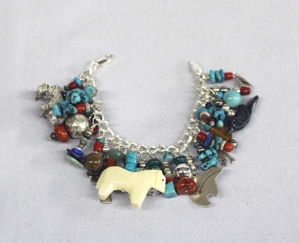 Western Sterling Charm Bracelet by Tamollies: Western Sterling Charm Bracelet by Tamollies, Sterling Silver Hollow Beads and Roadrunner Charm. Coral and Turquoise Beads. One of a kind charm bracelet by Tamollies. Measures 7" end to end.