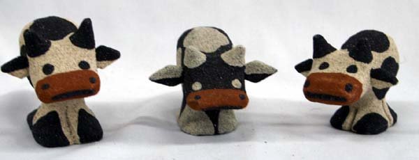 Hand Carved Balinese Albezia Wood Cows: Hand Carved Balinese Albezia Wood Cows covered with a coat of natural sand from the beaches in Bali, the black sand is from the north of the island, the natural tone sand is from the sought and the re