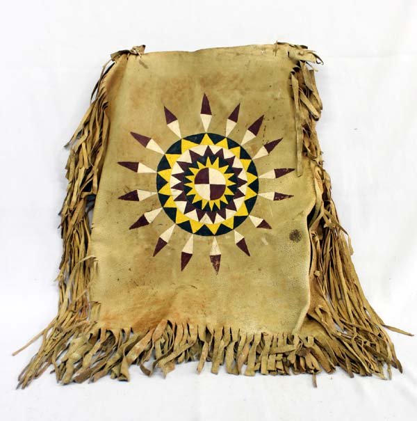Sioux Parfleche Design Vest: Native American Sioux Parfleche Design Vest, fringed and tan in color, circular geometric design on front in hues of red, white, black, and yellow, left shoulder needs repaired, missing a leather tie 