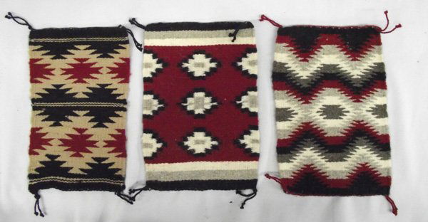 Navajo Rug Samplers: Three Native American Navajo Rug Samplers. Three different, but traditional patterns in traditional colors of crimson red, black, grey, white, tan, off-white. Largest measures 10.5''x7.5''.