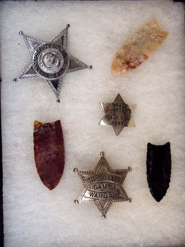 Collection 3 Arrowheads and 3 Badges: Collection 3 Arrowheads and 3 Badges. The arrowheads are approximately 2'' long. The largest badge is 2.5''x2.5''. The badges say, ''Fayette Co. Deputy Constable,'' Head Quarters Y.P.S.L. Dept.'' and 