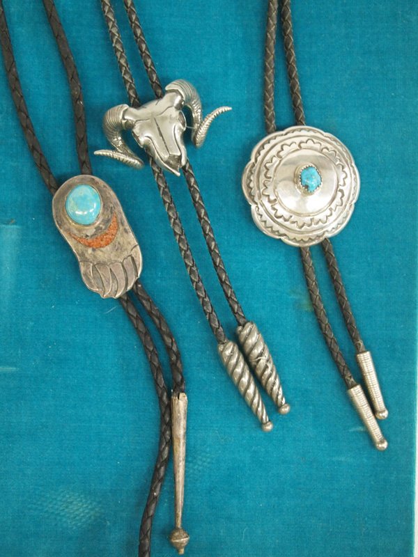 3 Vintage Navajo Bolo Ties, some sterling silver: Native American Navajo Bolo Ties, #1 is a pewter rams skull and is signed on back. It has pewter tips. #2 is sterling silver bear paw with turquoise cabochons and chip inlay coral. #3 is a concho styl