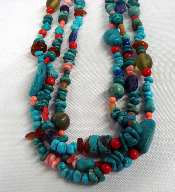 Southwestern Three Strand Multi Stone Choker: Three Strand Choker-Multi Stones, Sterling Cones. Colorful chocker, three strands of turquoise, coral, pink shell, lapis and amber chips with glass beads. The necklace measures 18'' with sterling silv